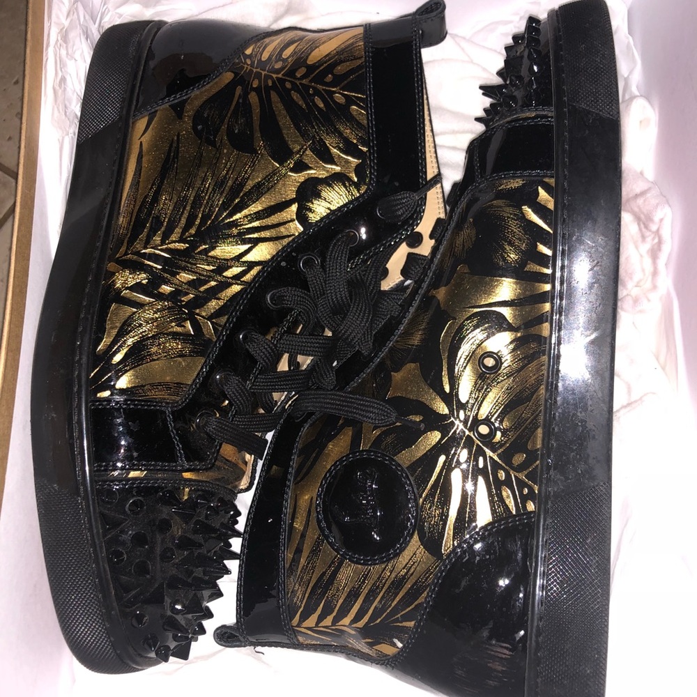 Black and gold men’s Christian Louboutin sneakers